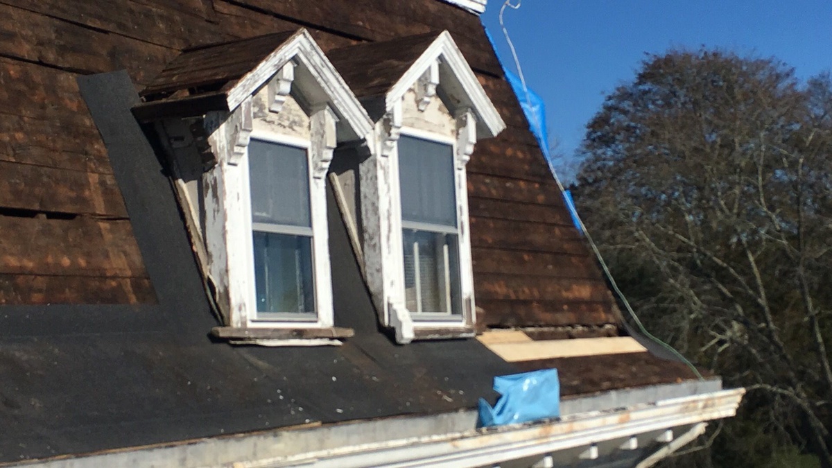 Original wood shingles exposed during Newport RI roof tear-off