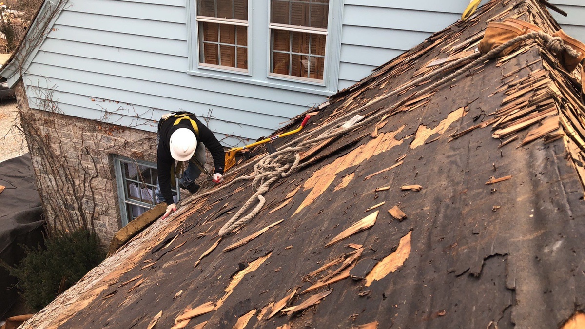 Old wood shingle roof being removed Warwick RI roof replacement