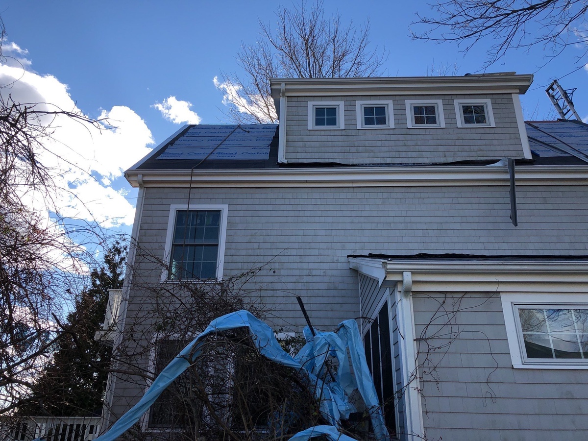 Storm tarp protecting Portsmouth RI home before roof replacement