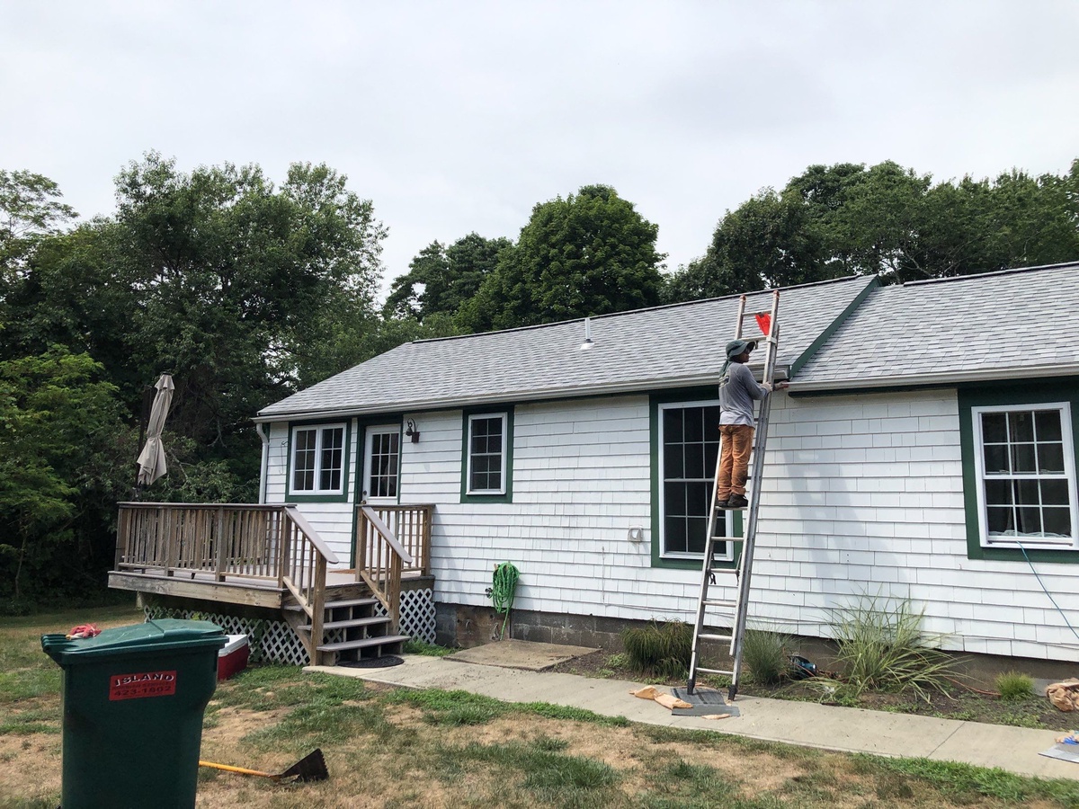 Crew working the eave line on Jamestown RI gutter installation