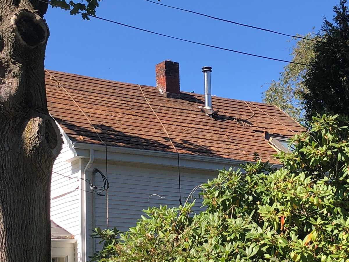 Old wind damaged wood roof Jamestown RI before replacement