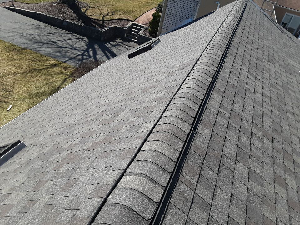 Roof edge and gutter line after Johnston RI storm damage roof replacement