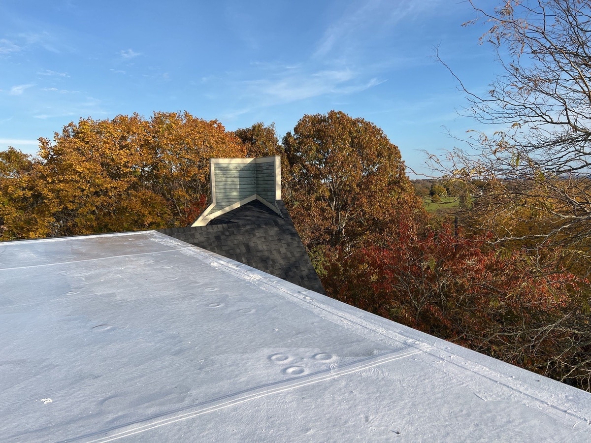 After — Westerly, RI Roof Repair: CertainTeed NorthGate Moire Black Shingles Over a Silicone-Restored Low-Slope Section