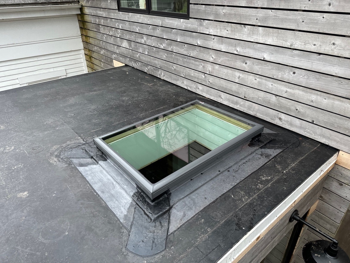 VELUX skylight set into black EPDM low-slope roof