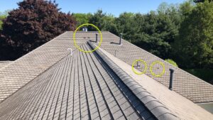 North Smithfield, RI roof with asphalt shingles showing storm damage and vents.