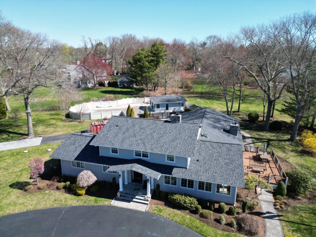 Warwick, RI residential roof replacement with Moire Black asphalt shingles. New roof, gutters, and home exterior.