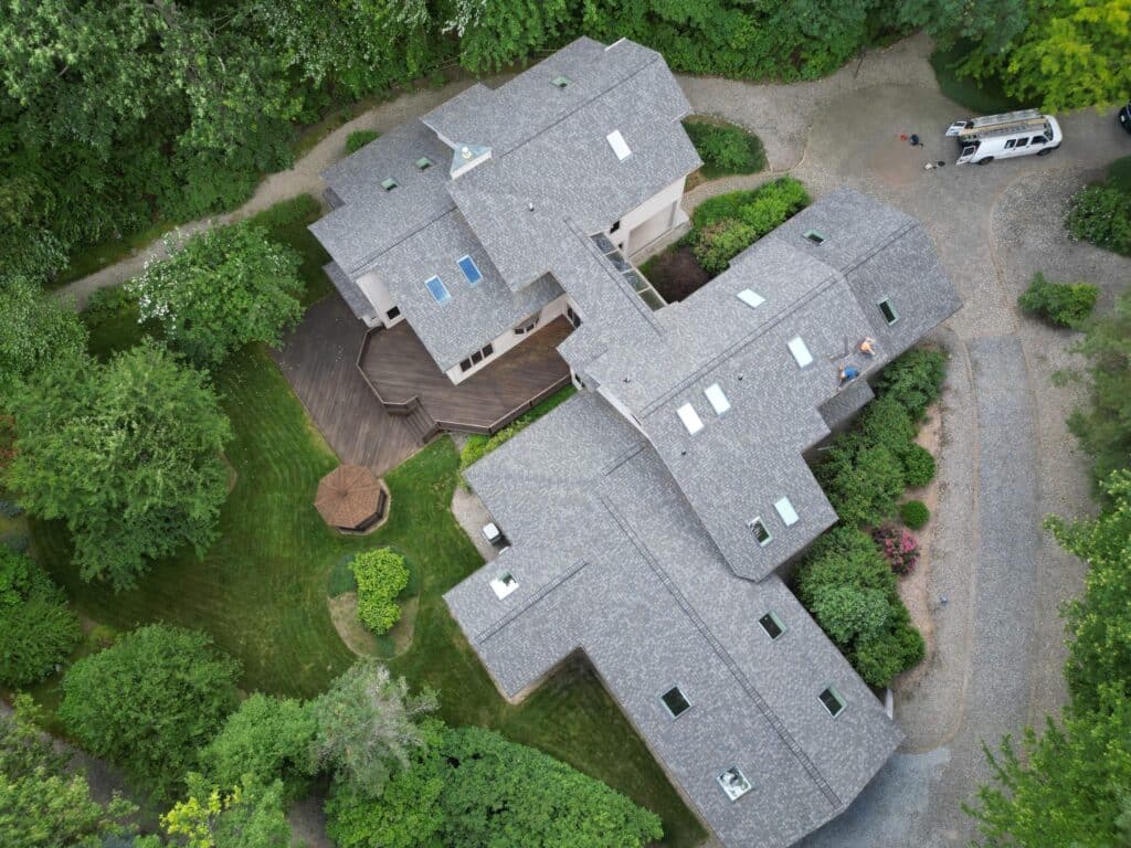Aerial view of a Cranston, RI home featuring a new roof and skylight installation by Pinnacle Roofing & Skylights.
