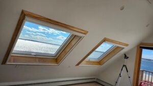 Two Velux skylights installed in an East Providence, RI home, offering a scenic water view.