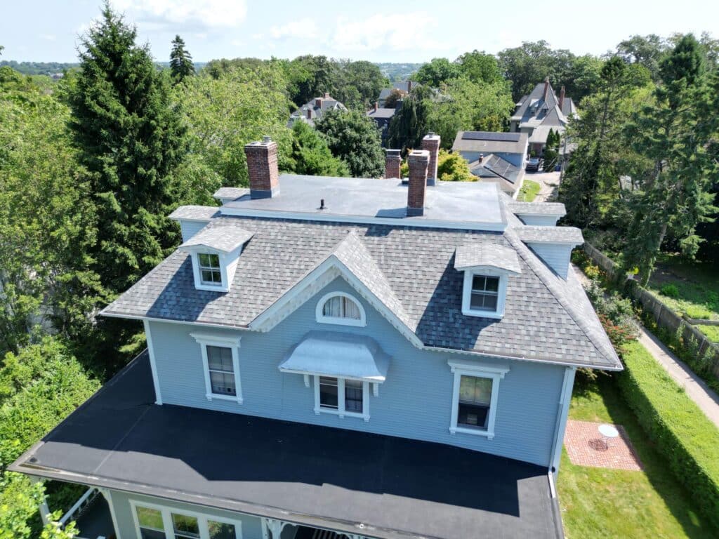 Newport RI roof replacement on a blue home with dormers and asphalt shingles