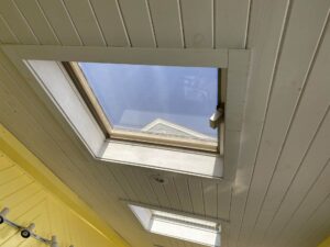 Skylight installation in North Smithfield, RI, showing a Velux skylight on a bright, sunny day.