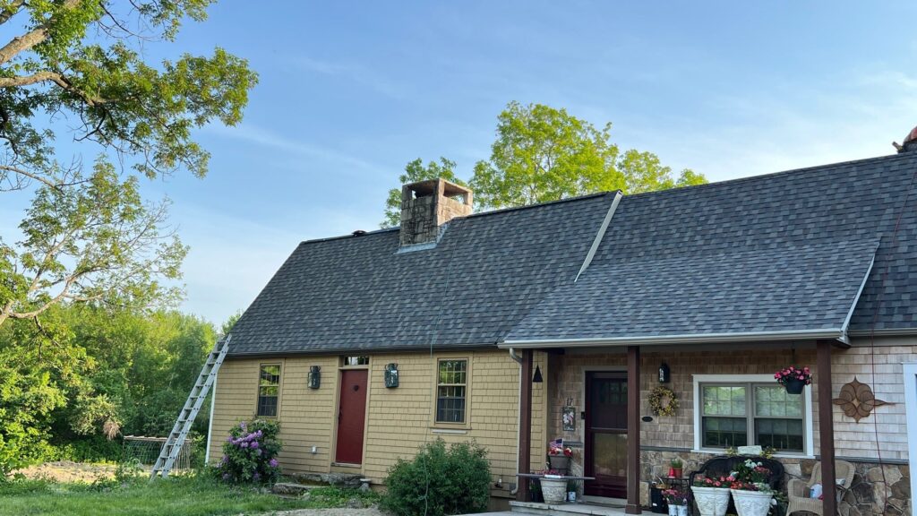Residential roof replacement in Foster, RI, showing new asphalt shingle roof, by Pinnacle Roofing & Skylights.