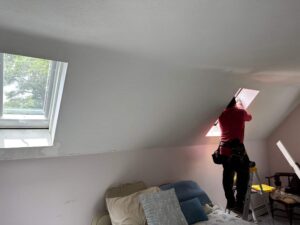 Velux skylight installation in Wakefield, RI. Interior view of new skylight being installed by technician.
