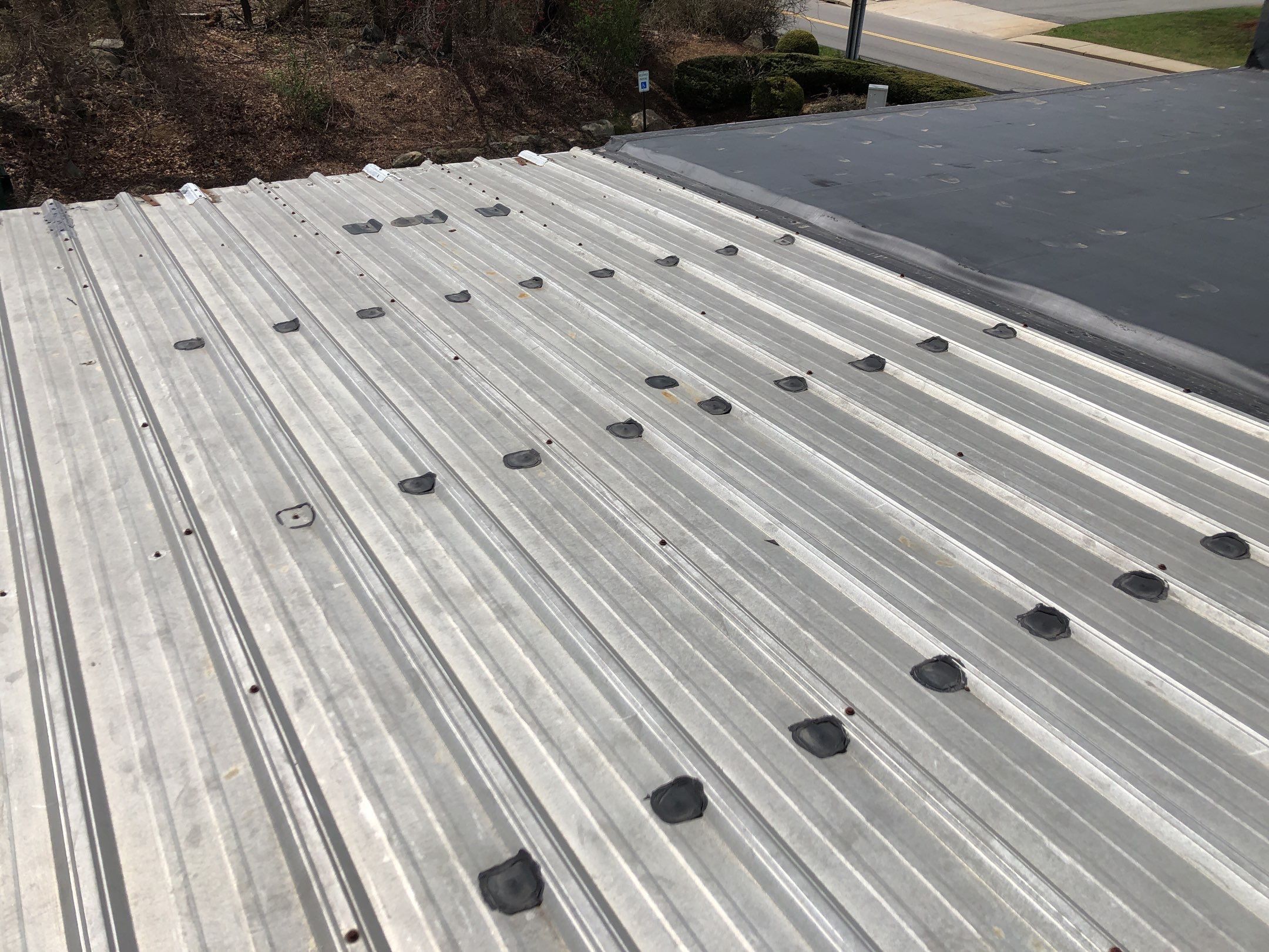Aerial view of repaired Cranston commercial metal roof