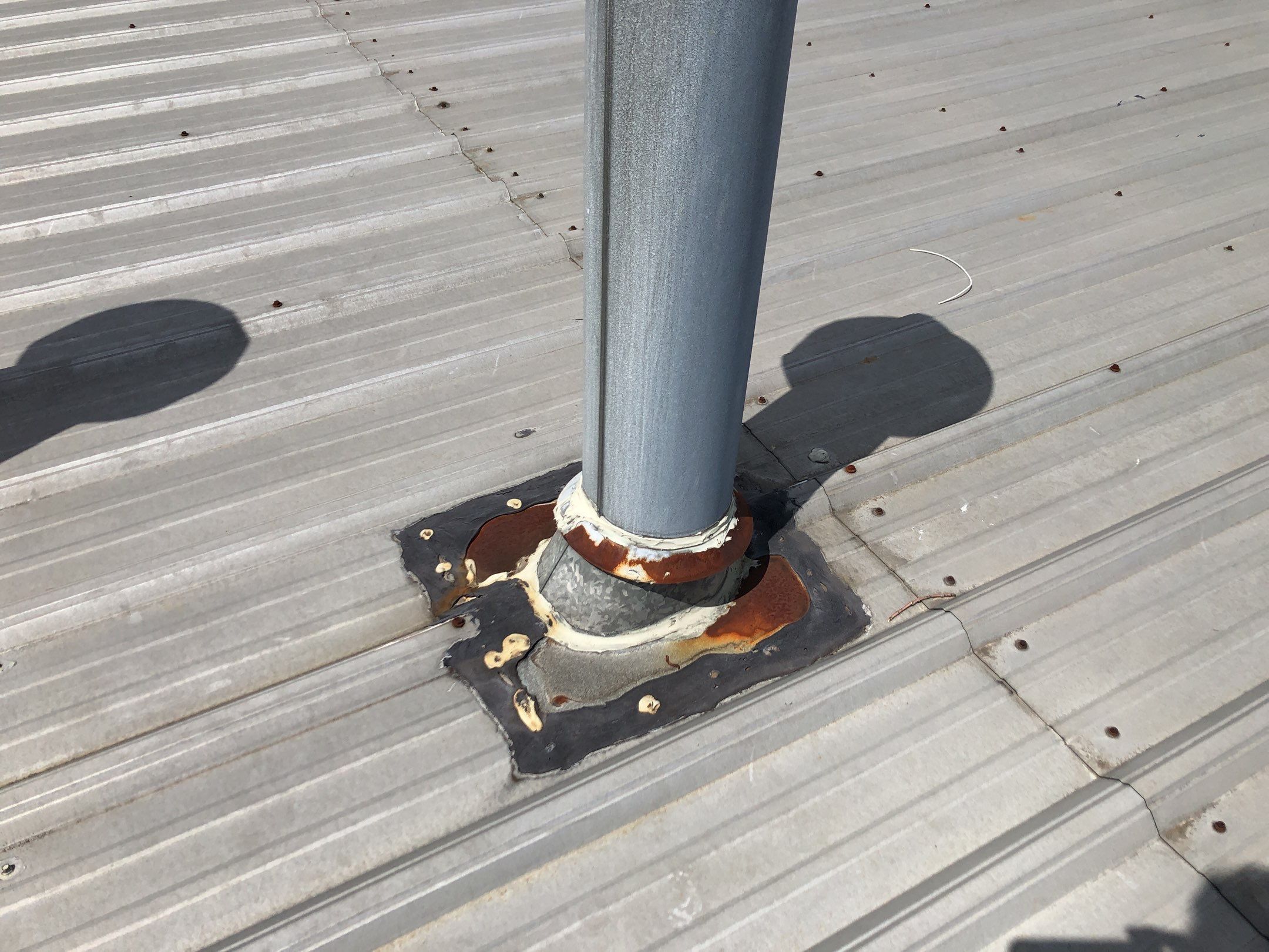 New pipe flashing sealed during Cranston metal roof repair