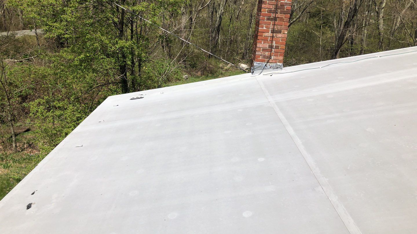 Foster, RI Commercial Flat-Roof Replacement — New Membrane on a Working Farm Building
