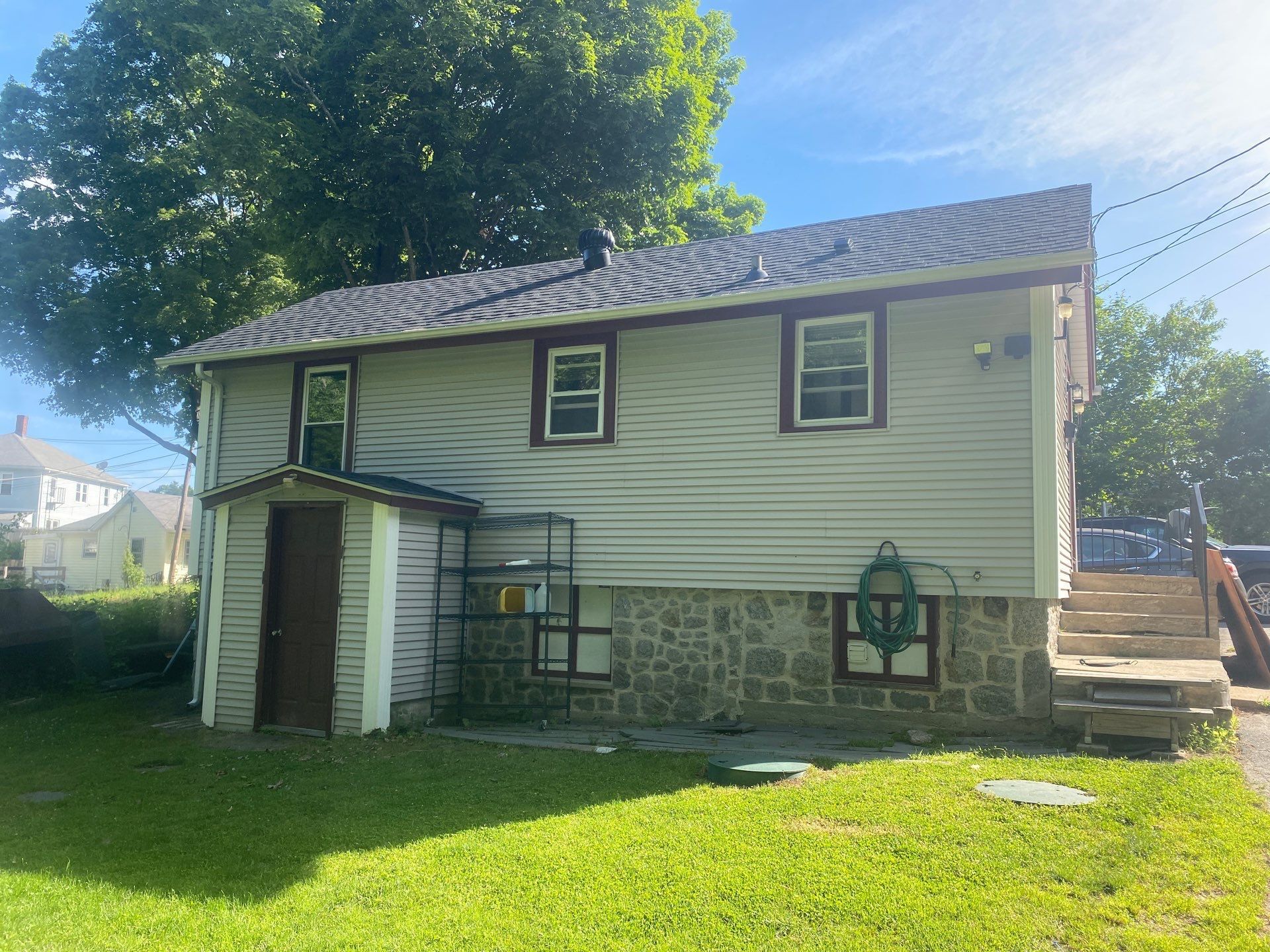 After — West Warwick, RI Siding: New Vinyl Siding with Trim & Stone-Veneer Accent
