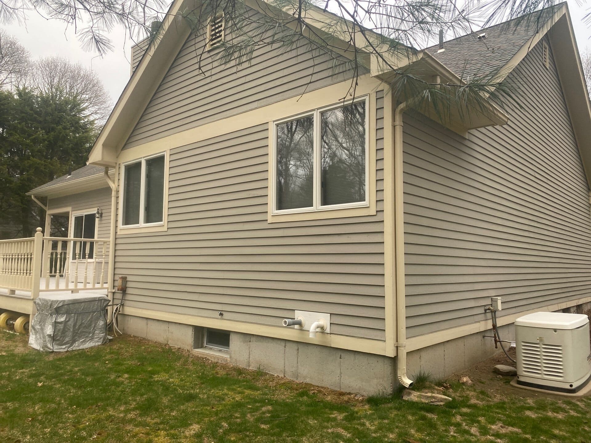 After — Wakefield, RI Siding Replacement: Vinyl Clapboard Wraps a Two-Story Home in Fresh, Low-Maintenance Curb Appeal