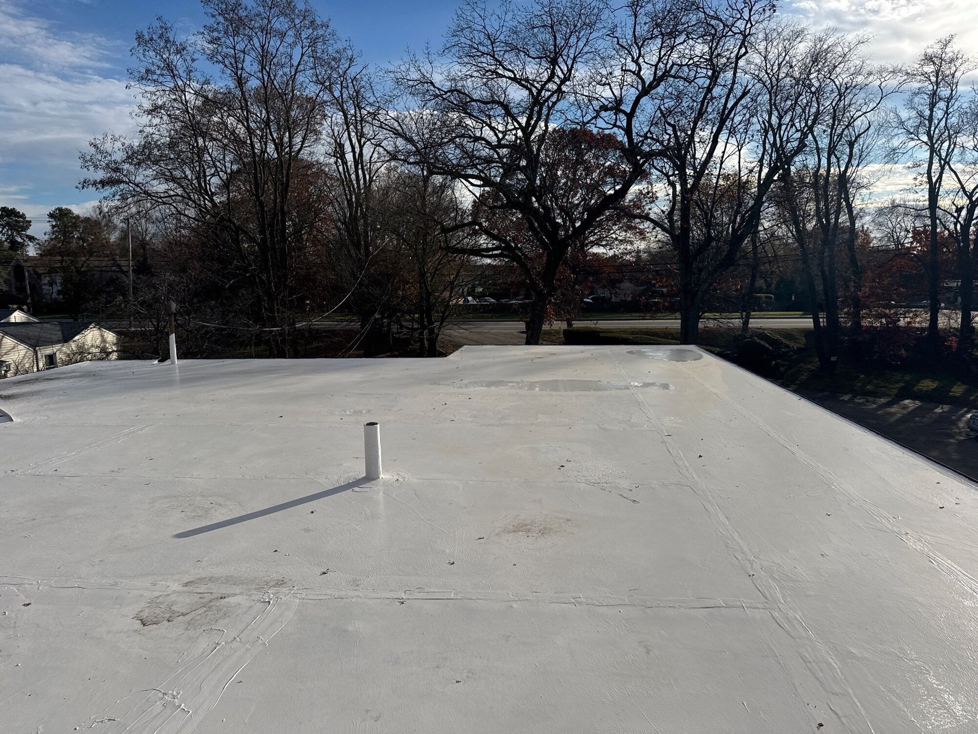 After — Warwick, RI Commercial Roofing: Seamless Silicone Coating on a Multi-Unit Flat Roof