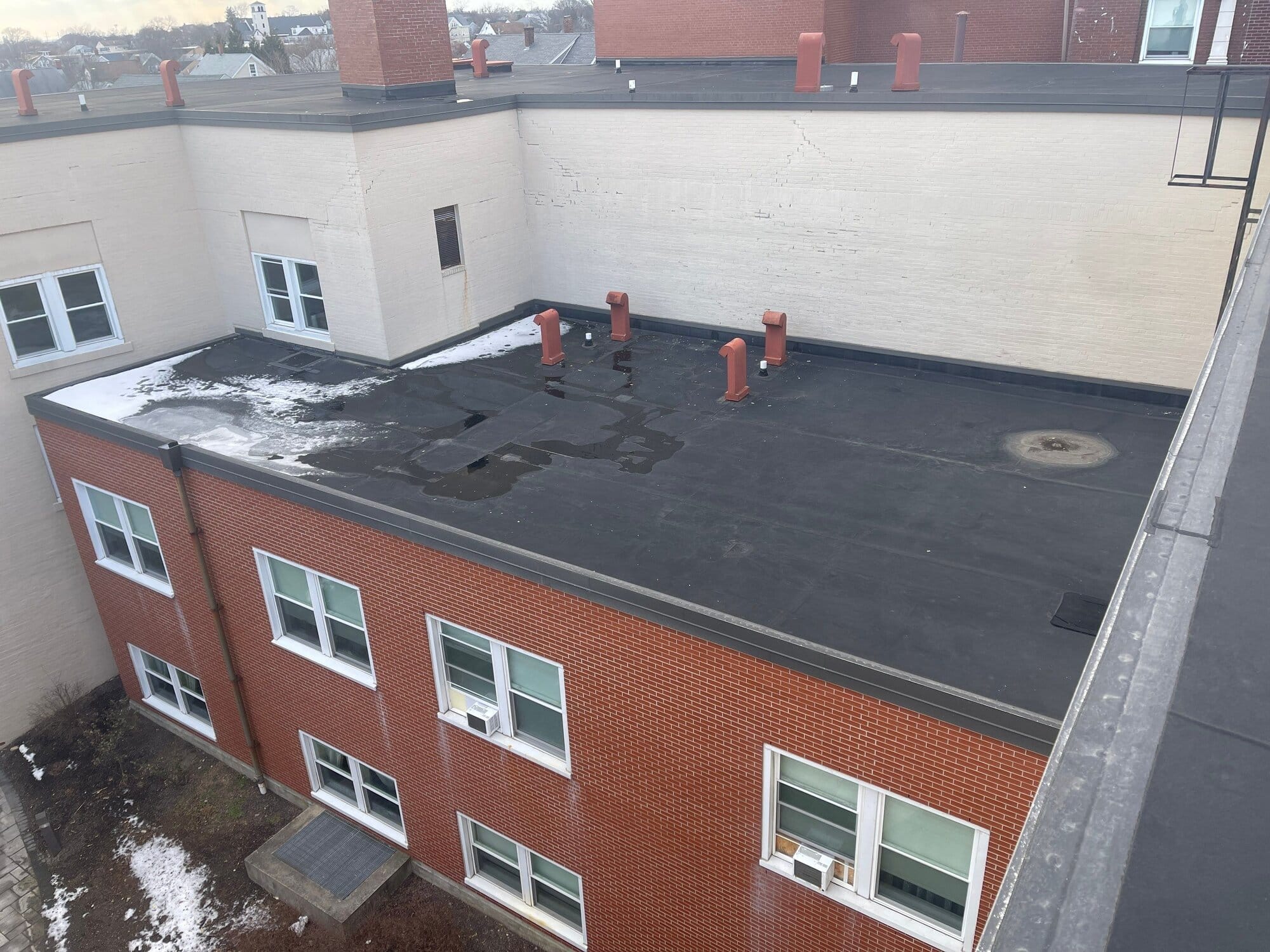 East Providence, RI Commercial Roofing: Low-Slope Flat Roof System on a Large Brick Building
