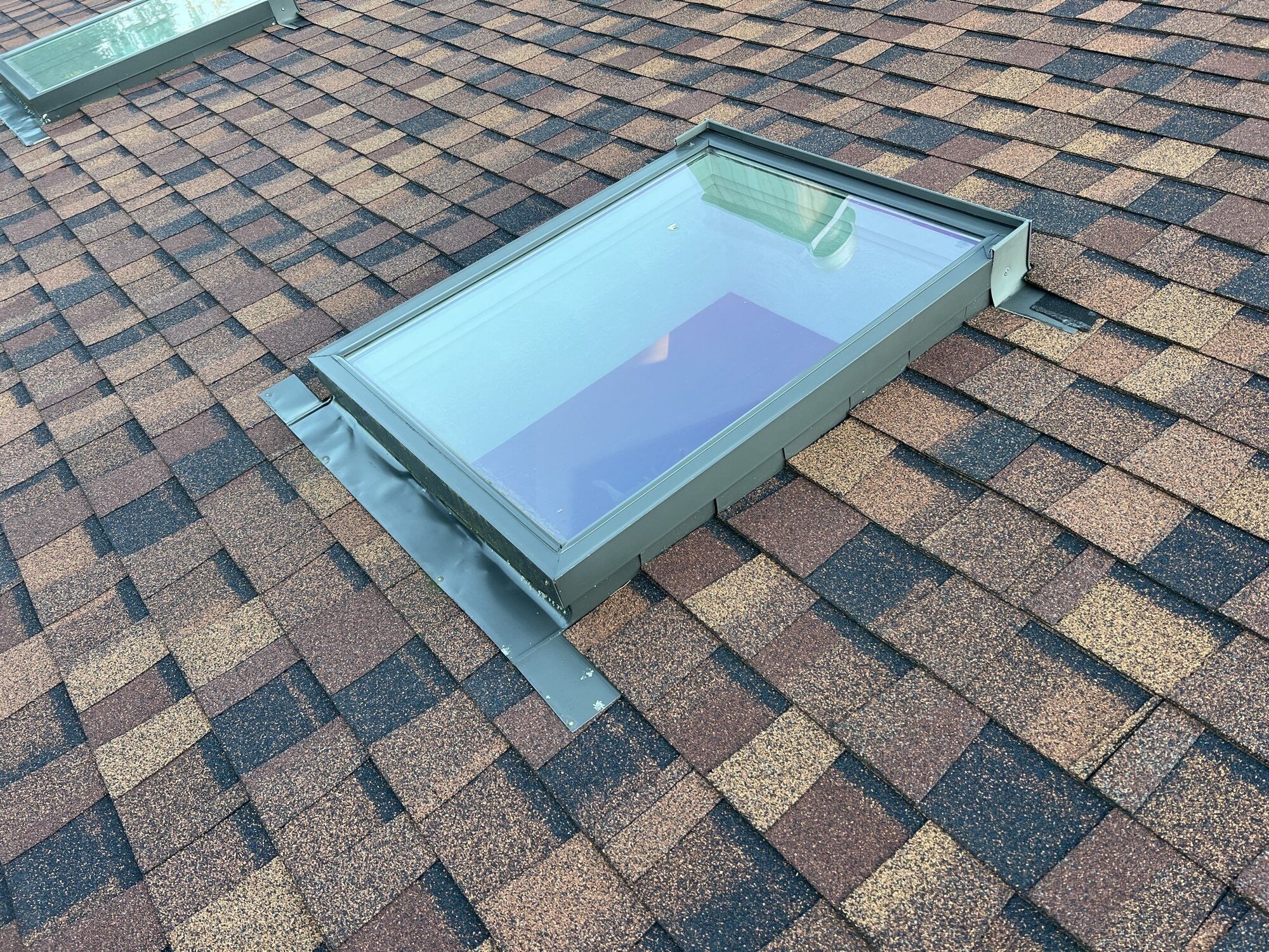 Deck-mounted skylight set into the finished roof