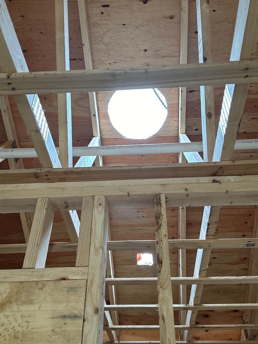 Rear elevation of completed Barrington new construction showing roof lines and exterior systems
