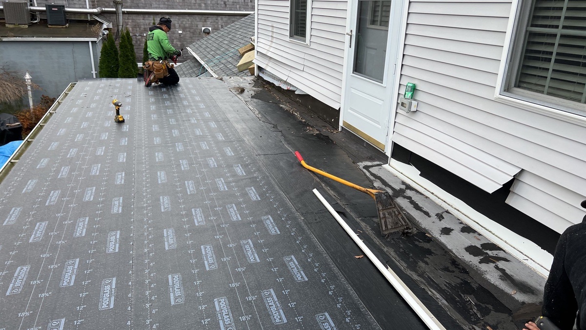 Transition detail between shingle and flat roof sections Jamestown RI