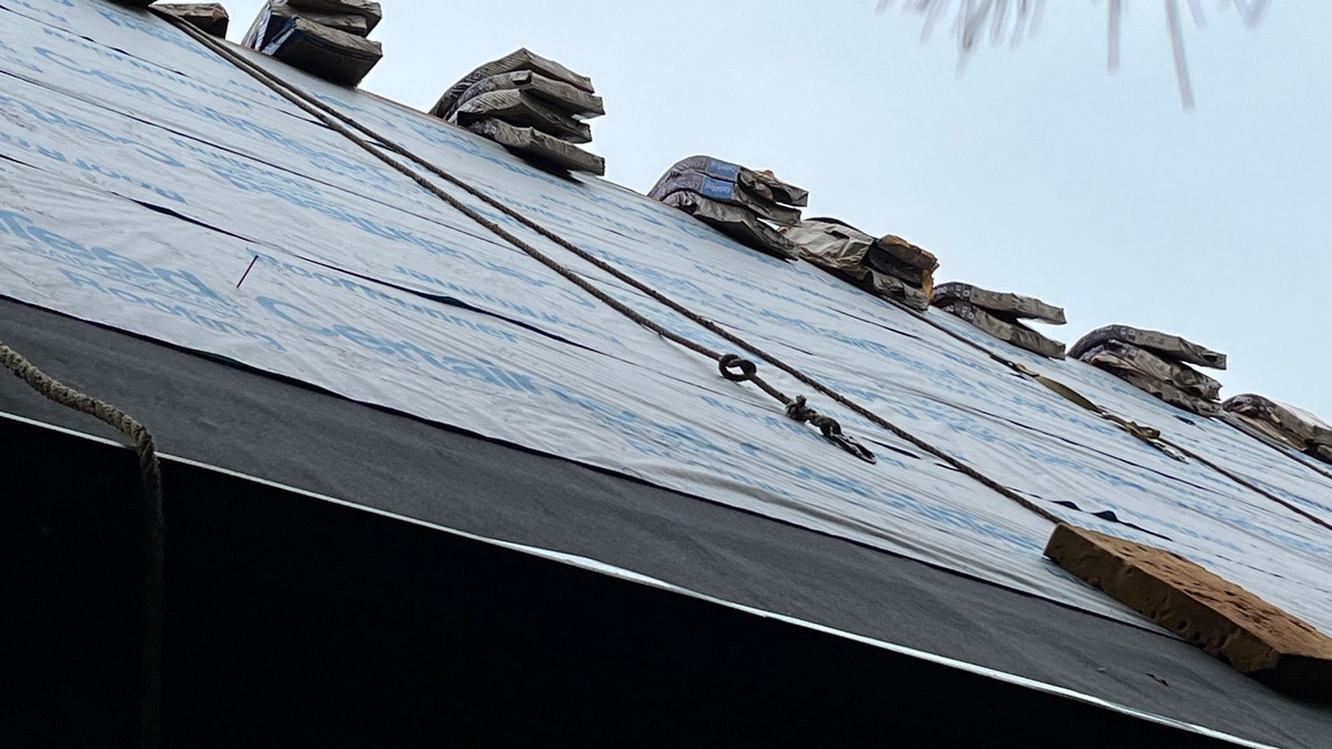 CertainTeed underlayment and shingle bundles staged on roof during installation in Jamestown RI