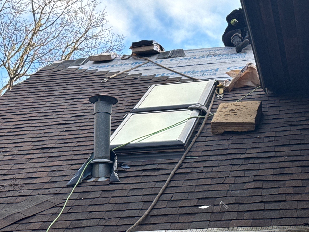 Side view of completed roof and skylight installation on Commodore Perry Highway home