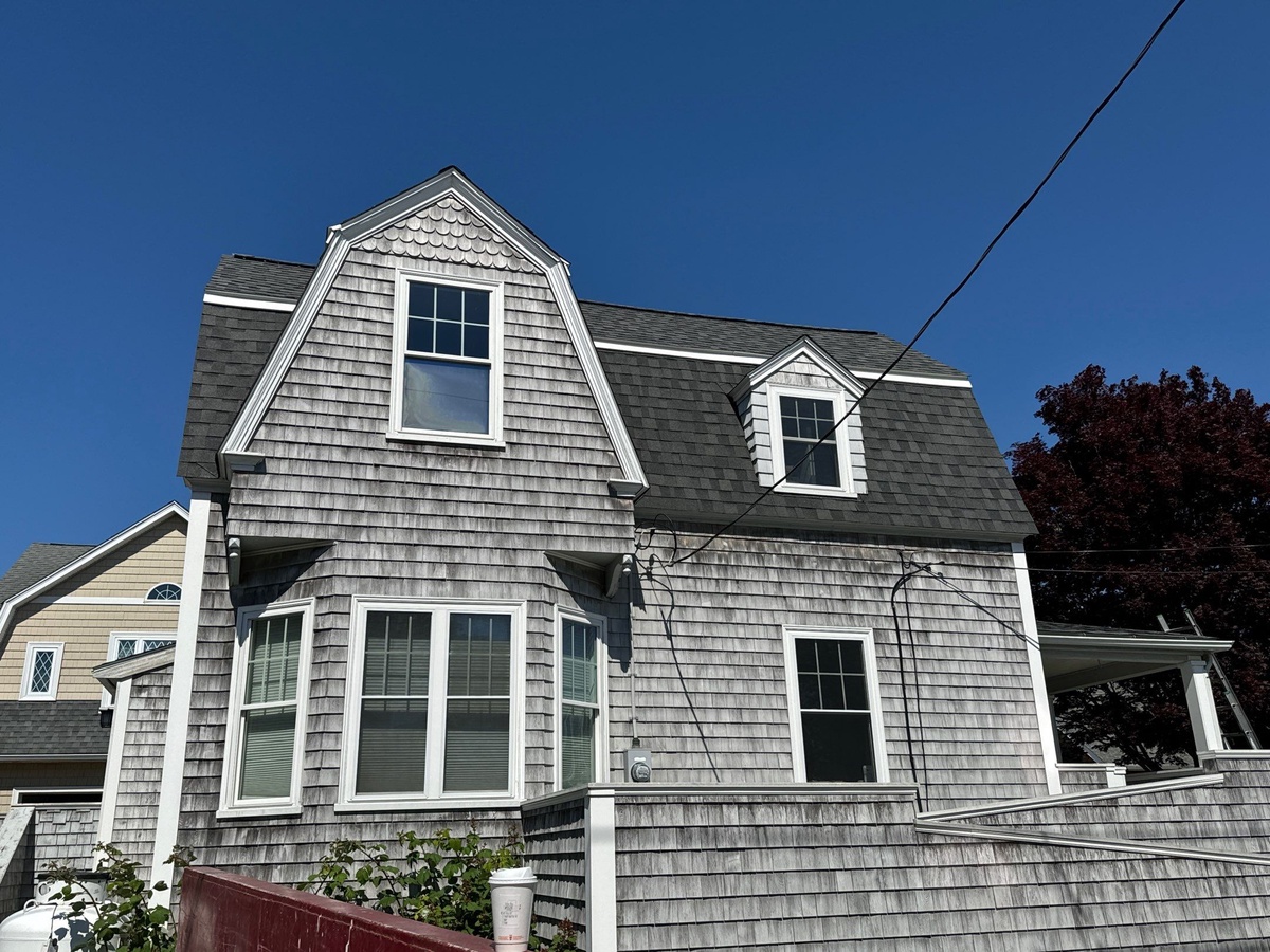 Mansard roof transition detail with CertainTeed shingles on Jamestown building