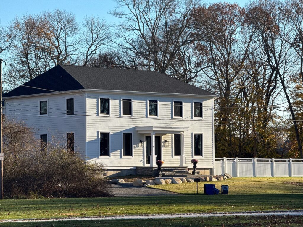 Completed new construction in Barrington RI with CertainTeed Landmark Premium Moire Black roof and Hardie Panel siding by Pinnacle Roofing