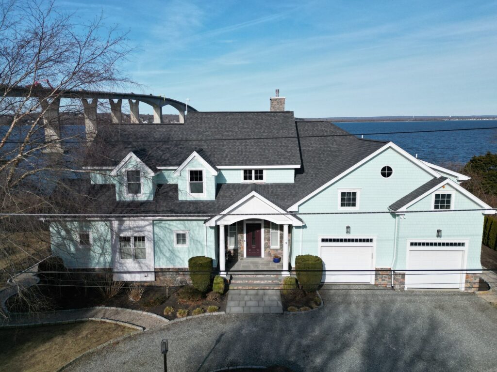 Jamestown RI waterfront home after James Hardie Shake Shingle siding and Landmark PRO Pewterwood roof by Pinnacle Roofing