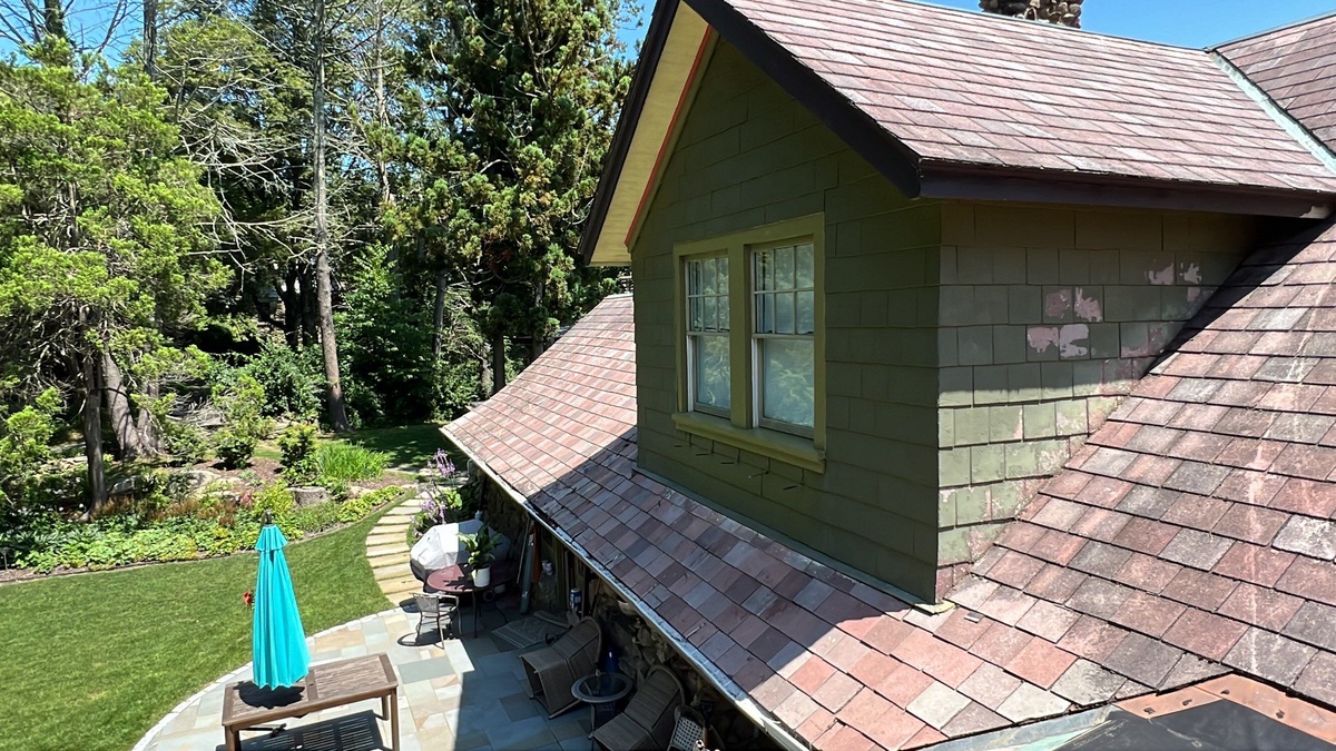 Rear drone view of historic hunting lodge with restored EPDM flat roof in Johnston RI