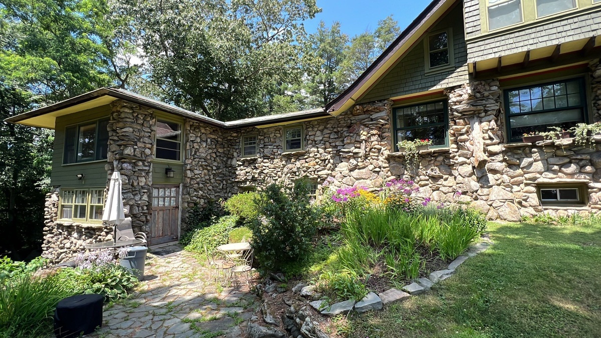 Front view of historic stone hunting lodge with restored flat roof in Johnston RI