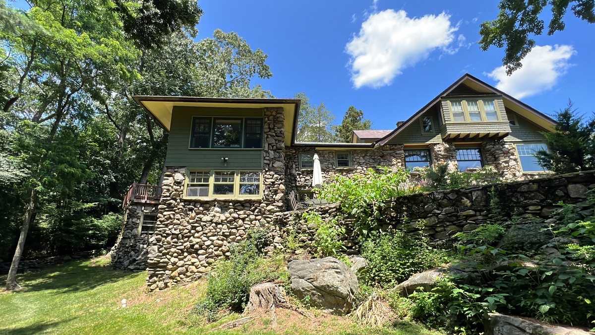 Historic hunting lodge grounds view showing completed EPDM roof restoration in Johnston RI