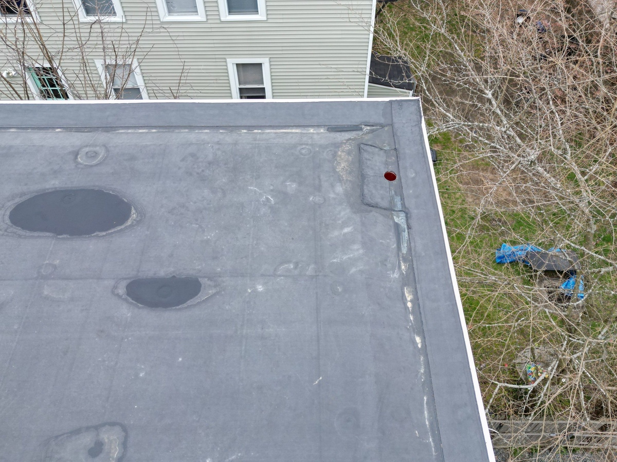 Old patched modified bitumen roof before replacement North Providence RI
