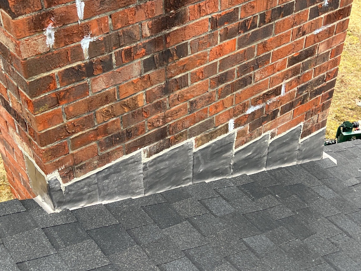 New step and counterflashing on brick chimney roof replacement Lincoln Rhode Island