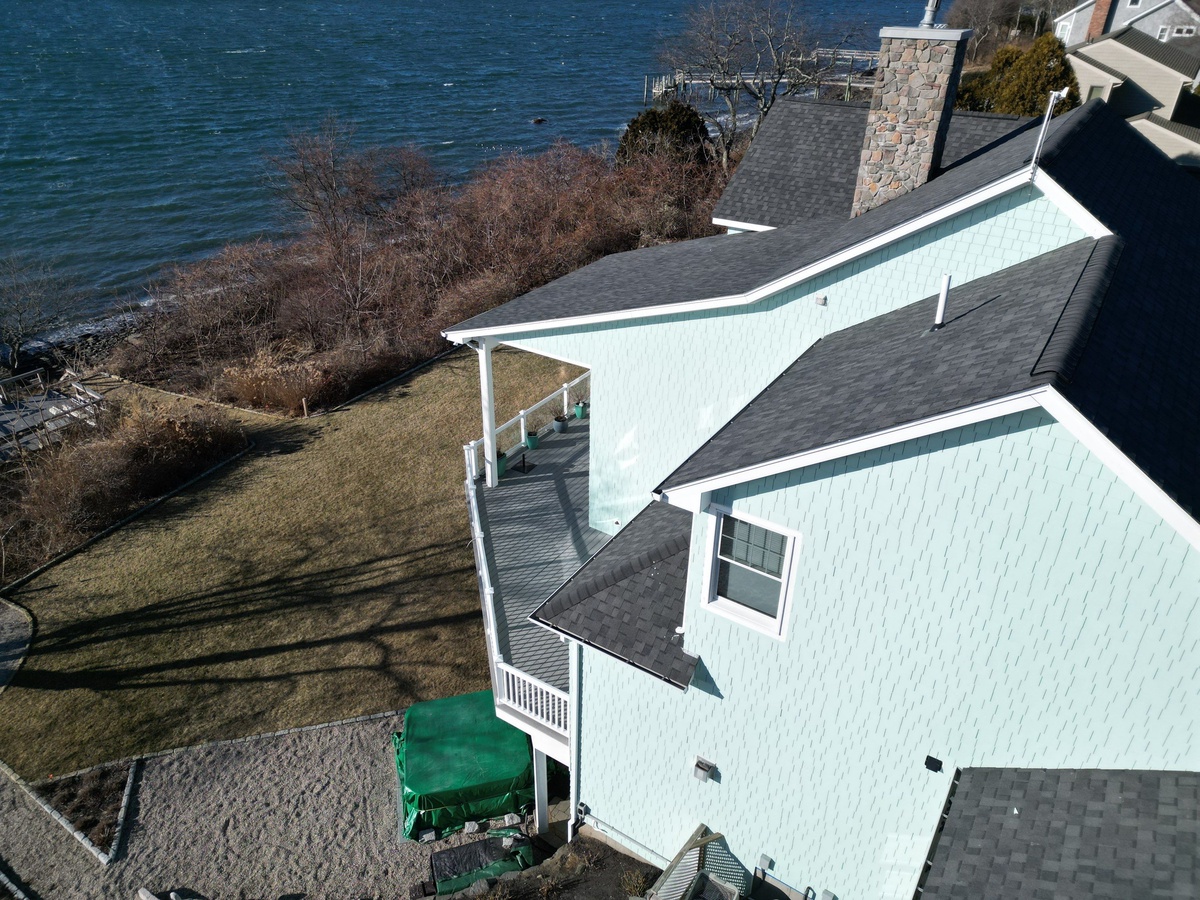 Waterside view of completed James Hardie siding and Landmark PRO roof in Jamestown RI