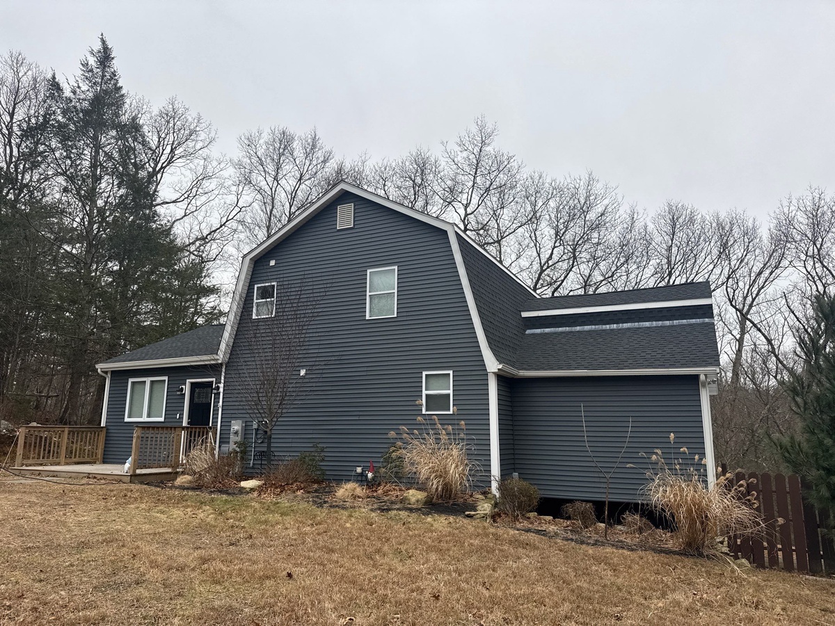 Showcase Project - GAF Timberline HDZ Johnston RI - Side elevation showing the completed Charcoal roof blending with the existing structure