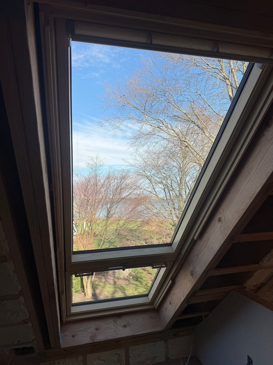 Showcase Project - VELUX Cabrio Balcony Jamestown RI - Interior view showing warm pine frame and triple-glazed glass flooding the room with light