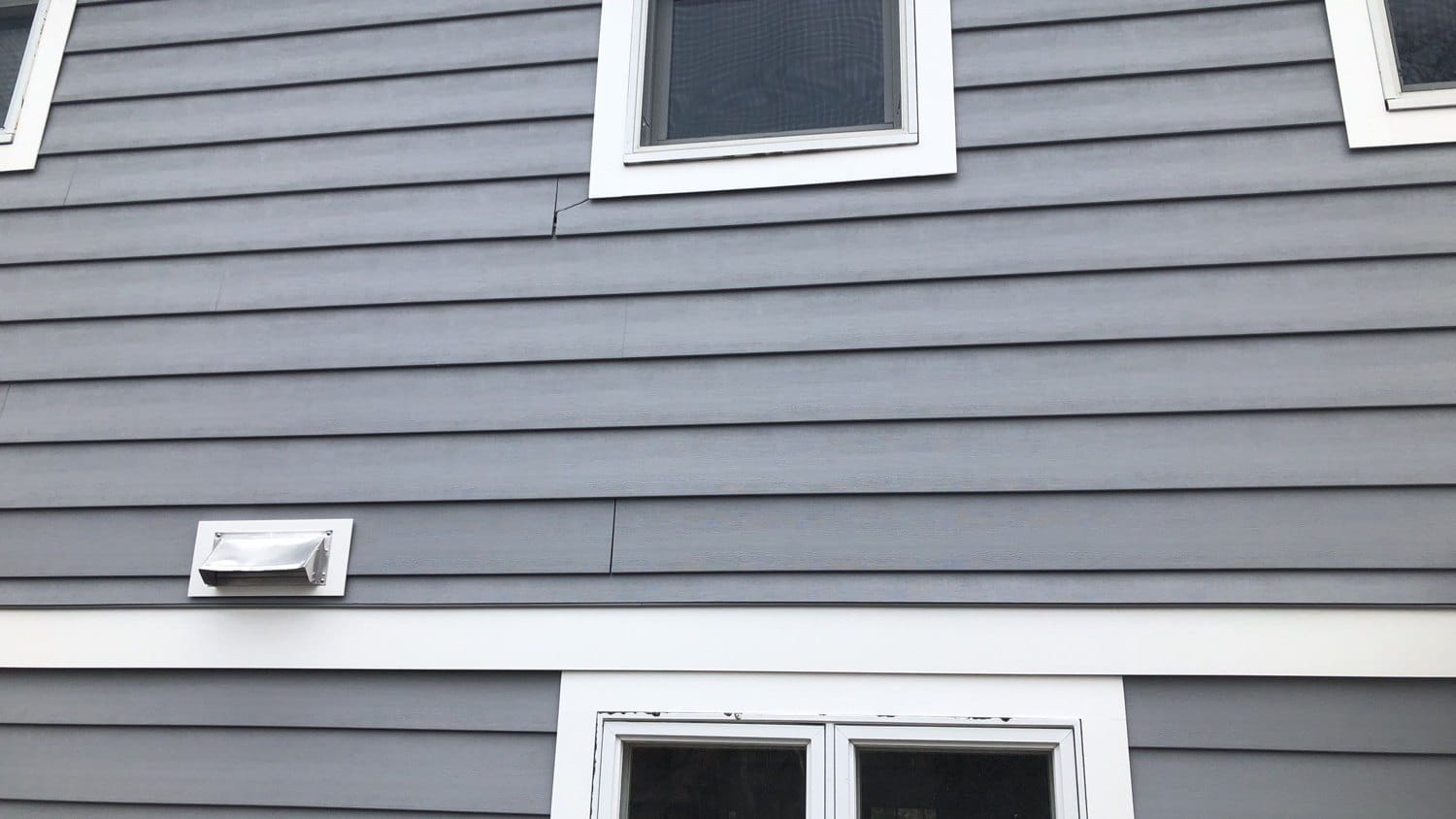 Everlast Composite Siding in Seaside Gray with an Owens Corning Duration Roof — South Kingstown