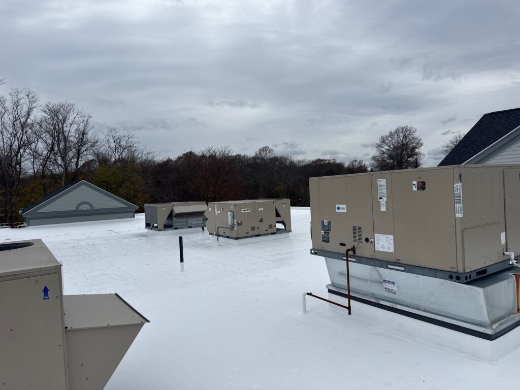 Commercial roofing in Barrington, RI with silicone coating — Project #12022 by Pinnacle Roofing & Skylights