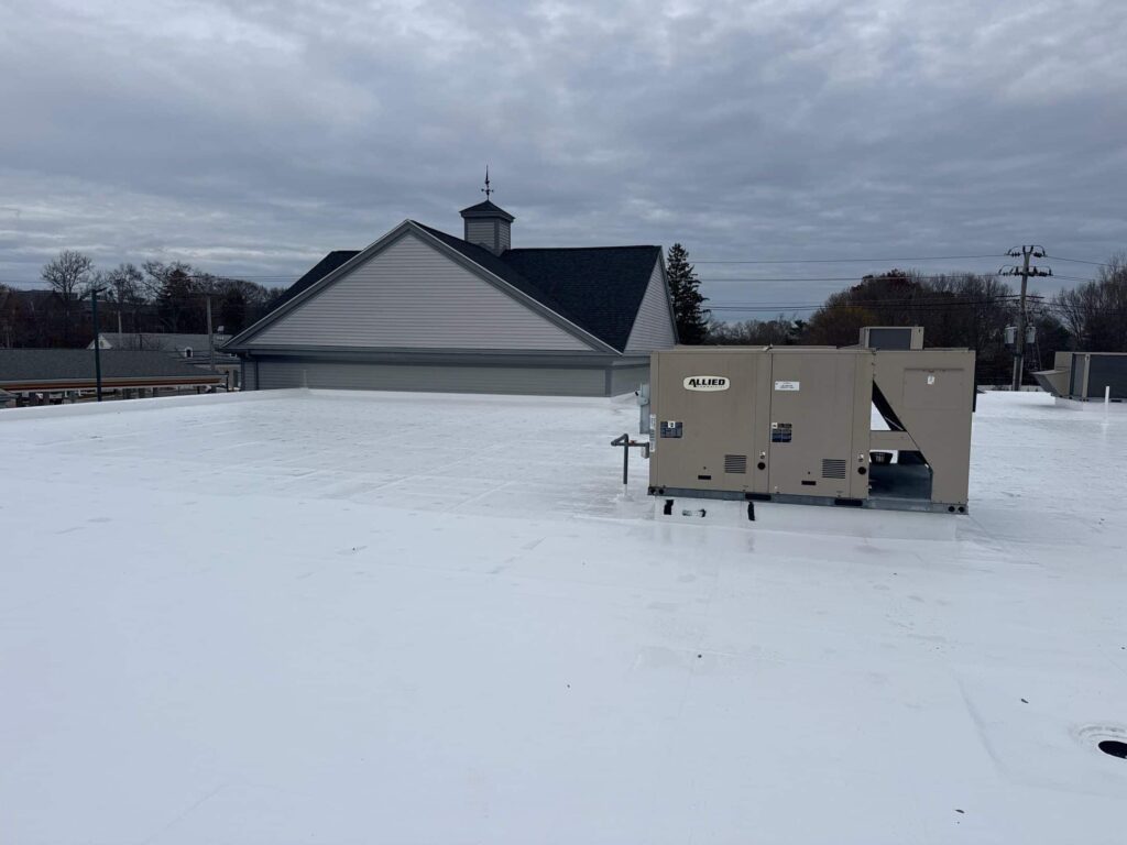Commercial roofing in Barrington, RI with silicone coating — Project #12054 by Pinnacle Roofing & Skylights