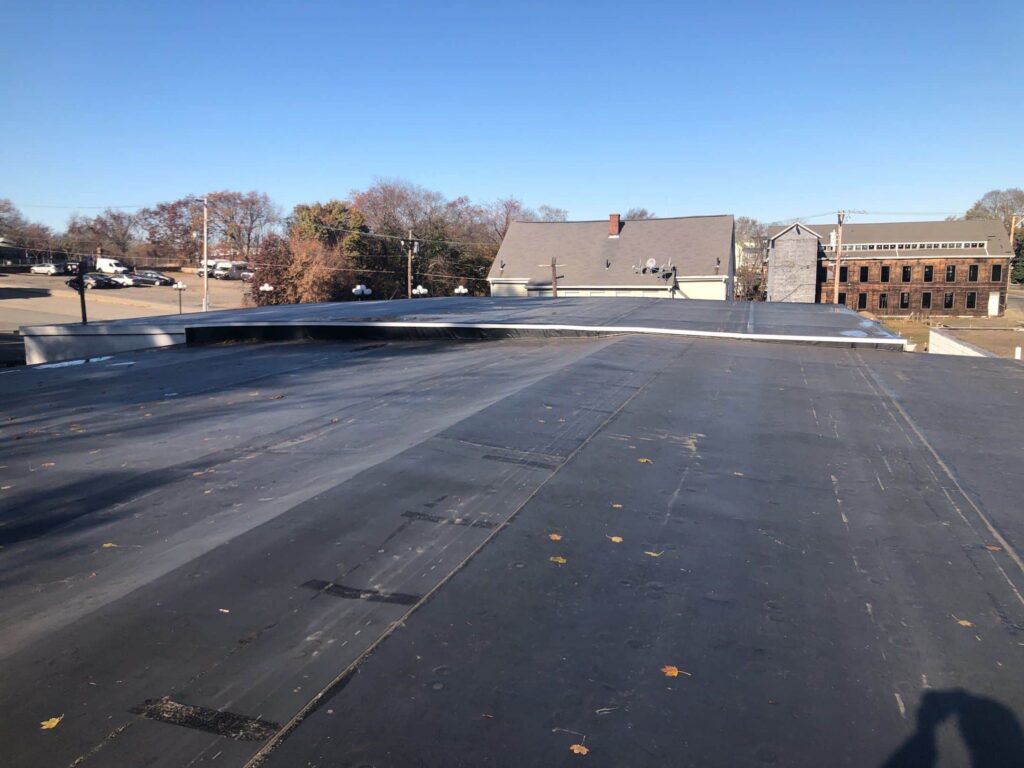 Commercial roofing in Central Falls, RI with EPDM rubber membrane — Project #11863 by Pinnacle Roofing & Skylights