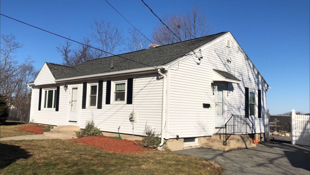 Roof replacement in Cranston, RI with asphalt shingles and white venal siding— Project #12155 by Pinnacle Roofing & Skylights