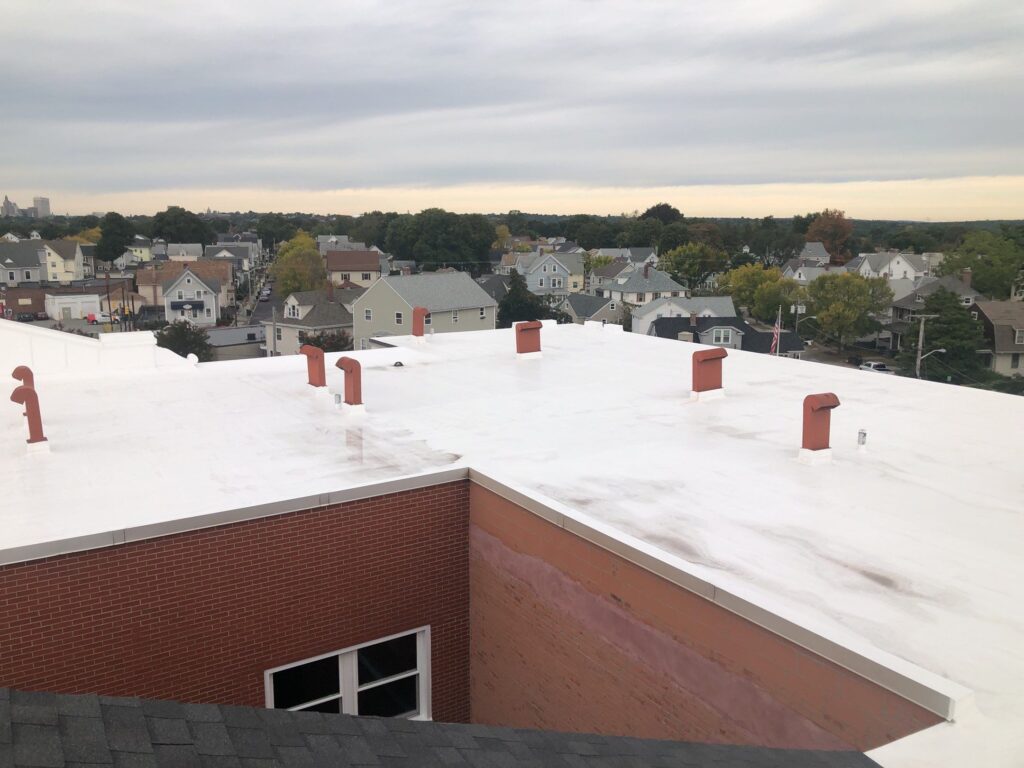 Commercial roofing in East Providence, RI with silicone coating — Project #11766 by Pinnacle Roofing & Skylights