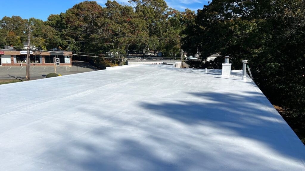 Commercial roofing in North Kingstown, RI with silicone coating — Project #11931 by Pinnacle Roofing & Skylights