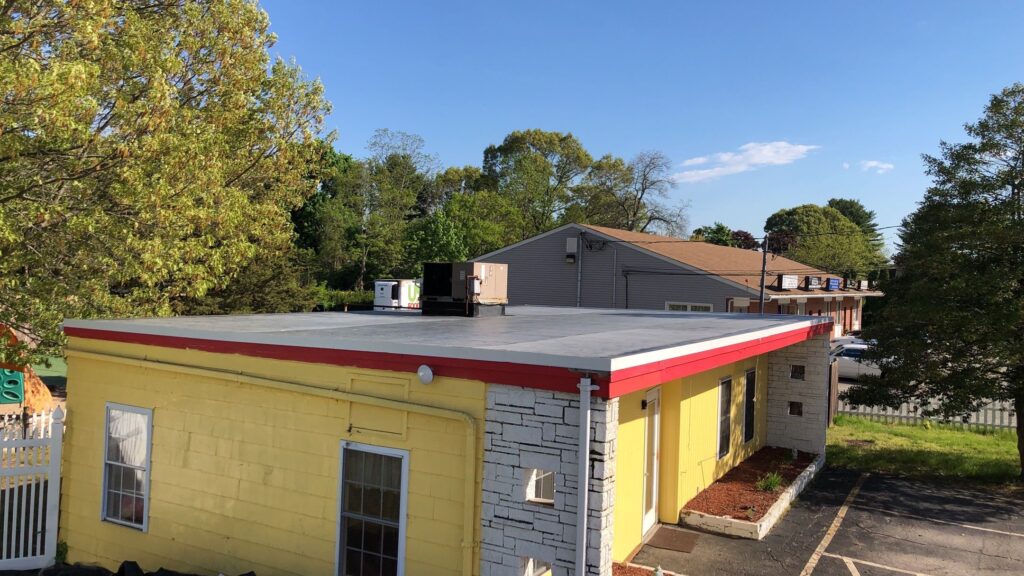 Commercial roofing in Warwick, RI with EPDM rubber membrane — Project #11748 by Pinnacle Roofing & Skylights