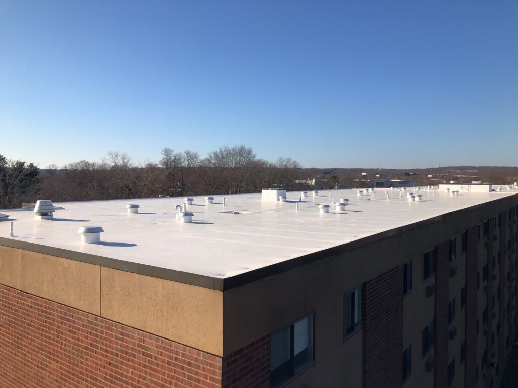 Commercial roofing in Warwick, RI with silicone coating — Project #11802 by Pinnacle Roofing & Skylights