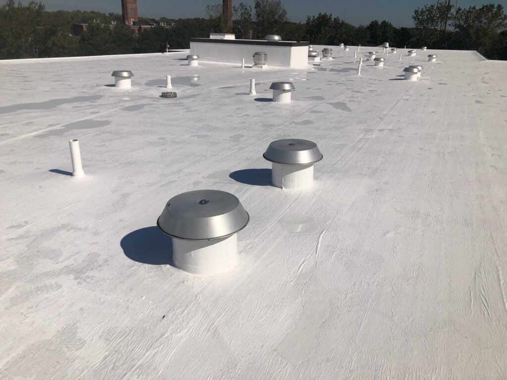 Commercial roofing in Warwick, RI with silicone coating — Project #11854 by Pinnacle Roofing & Skylights