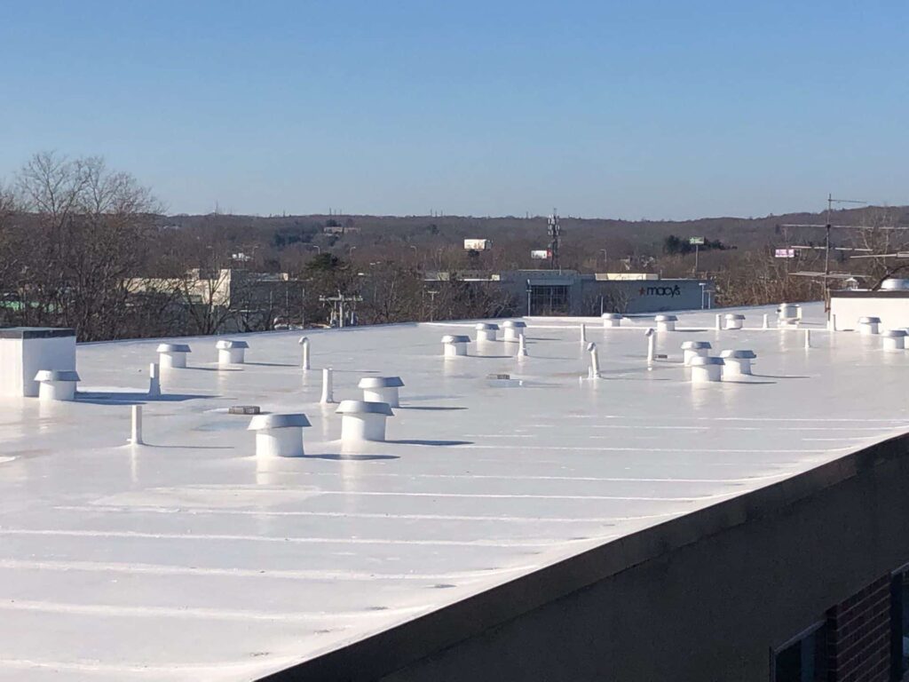 Commercial roofing in Warwick, RI with silicone coating — Project #11900 by Pinnacle Roofing & Skylights